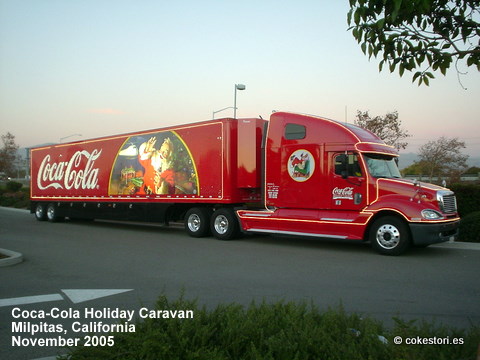 a coca cola truck that is driving down the road