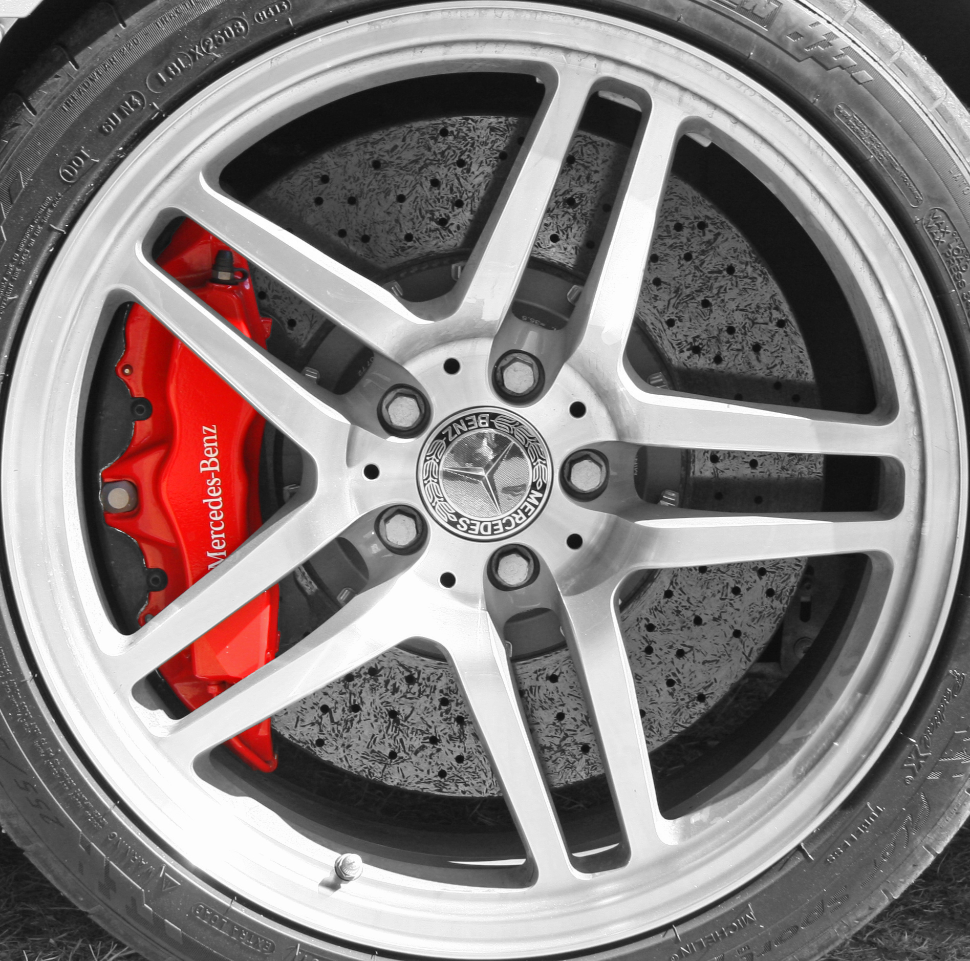 a car wheel on the floor with red ke pads