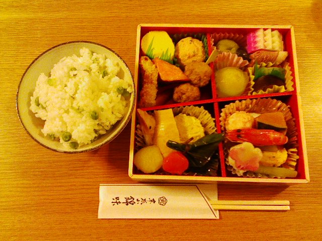 various foods are in a bowl with chopsticks on the table