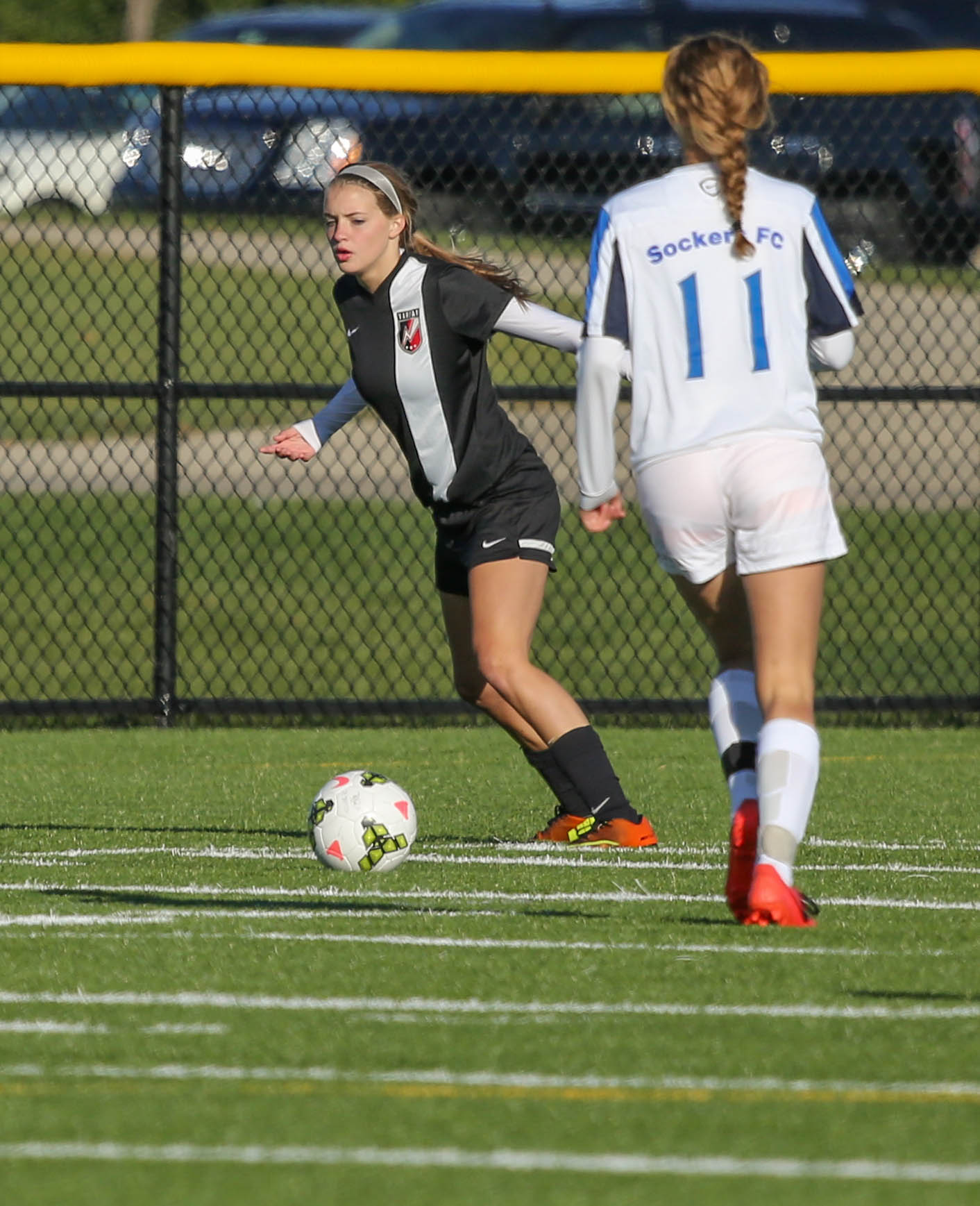 a girl in action on a soccer field