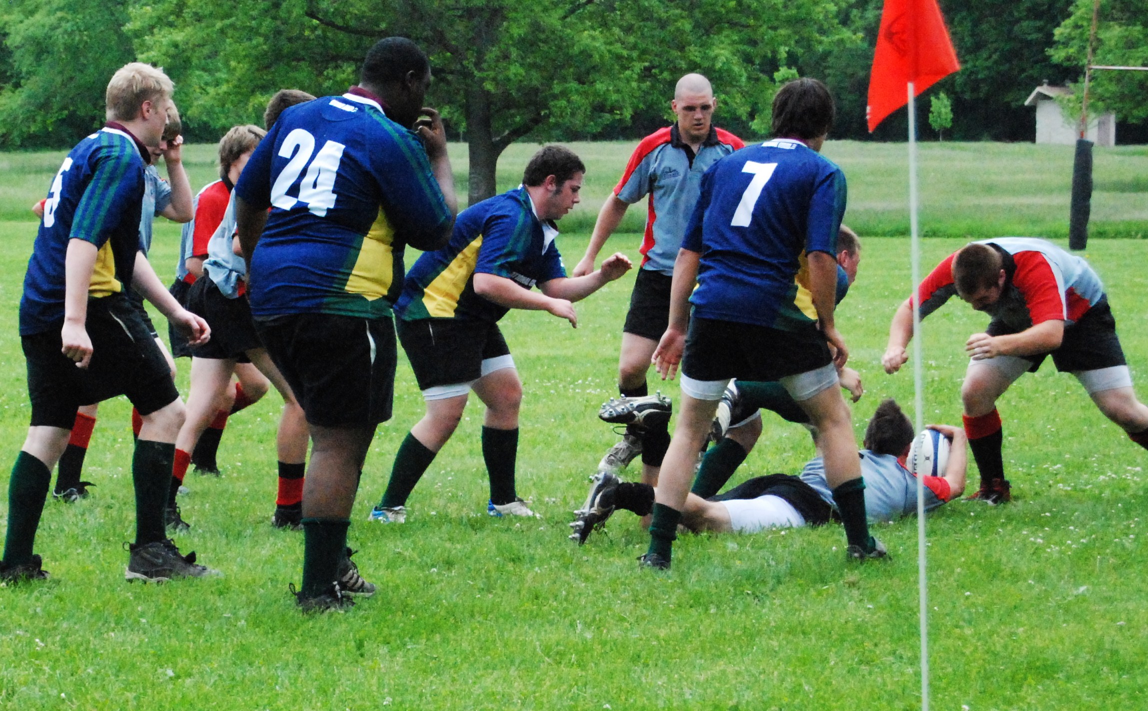 a group of people in uniforms are playing with a rugby ball