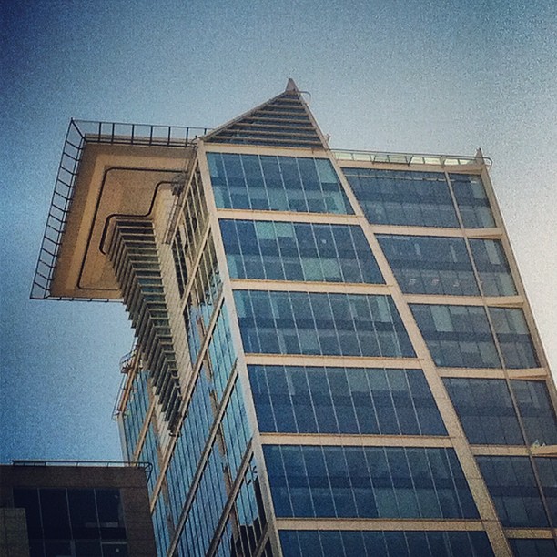 a tall building with windows under a blue sky
