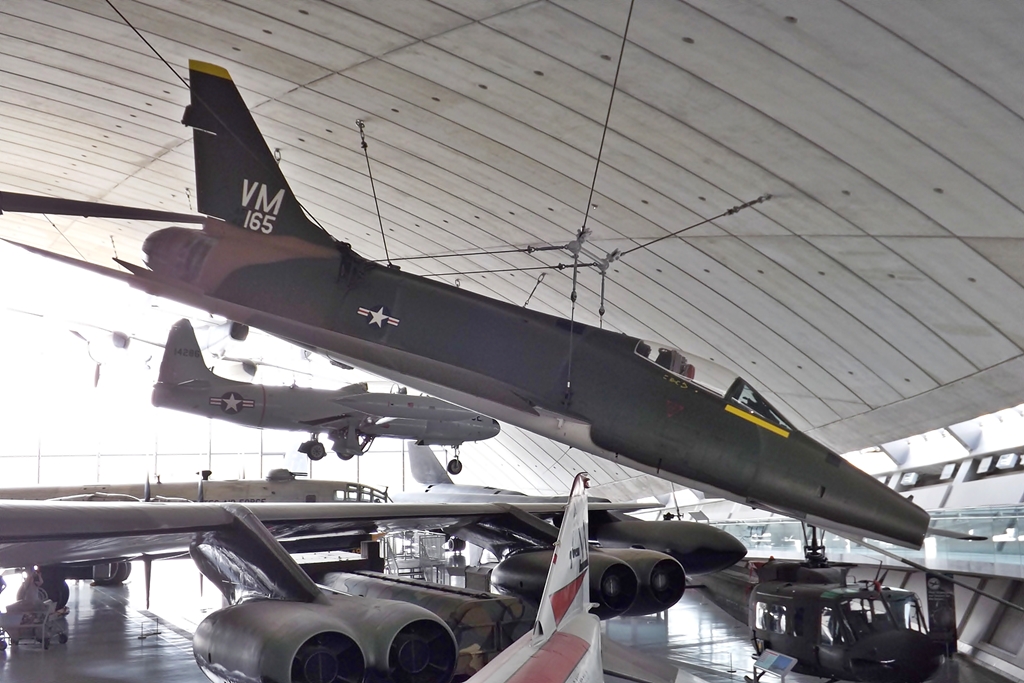 military planes hanging from the ceiling of an indoor aircraft museum