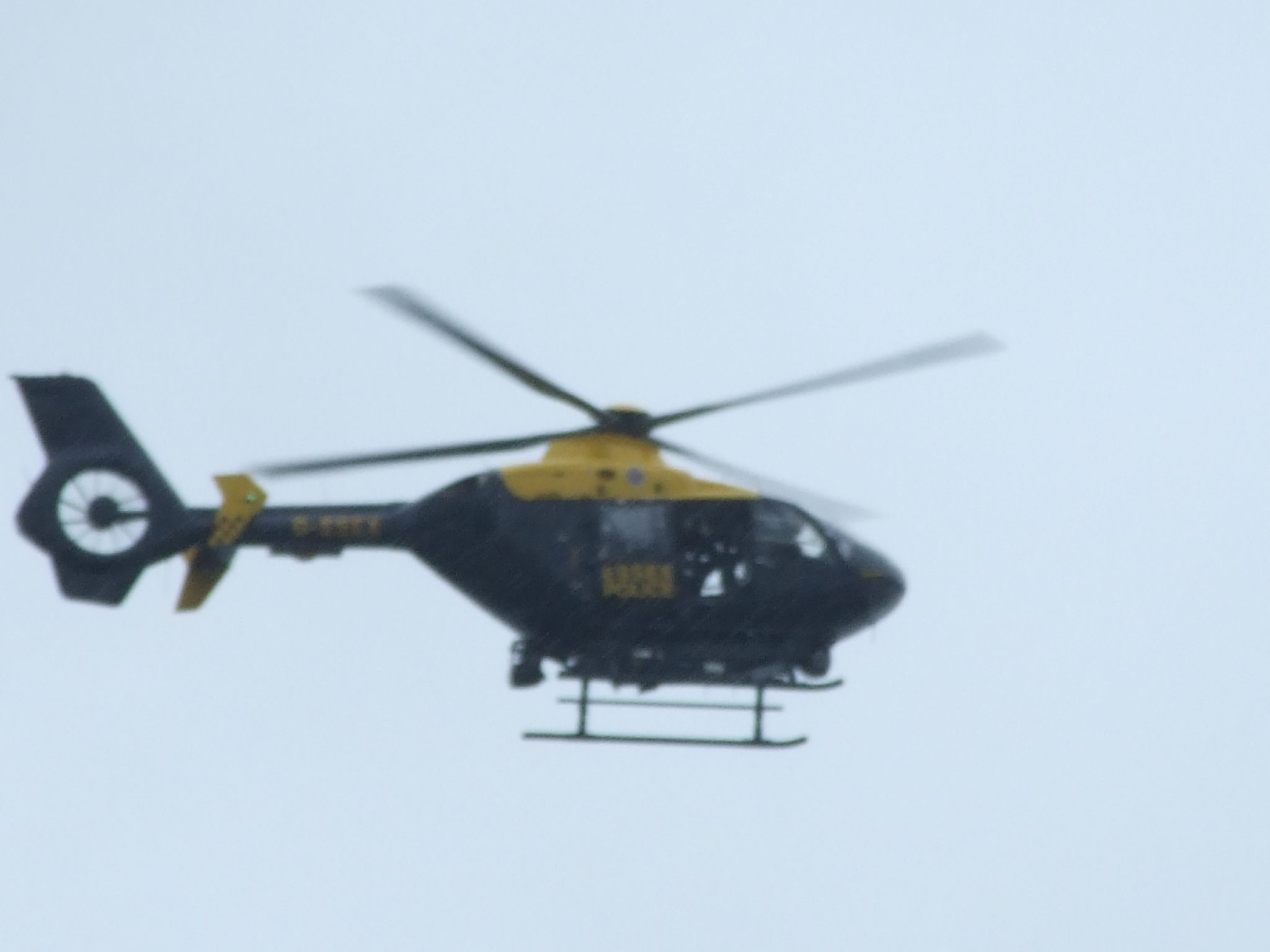 a large helicopter with two propellers flying in the sky