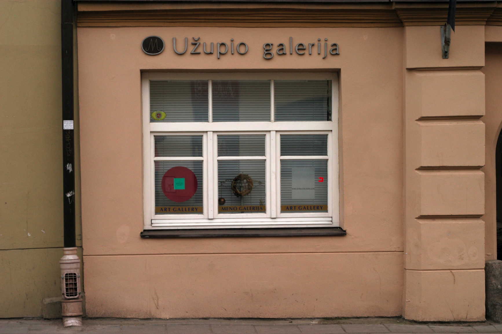 a large window next to a tan building