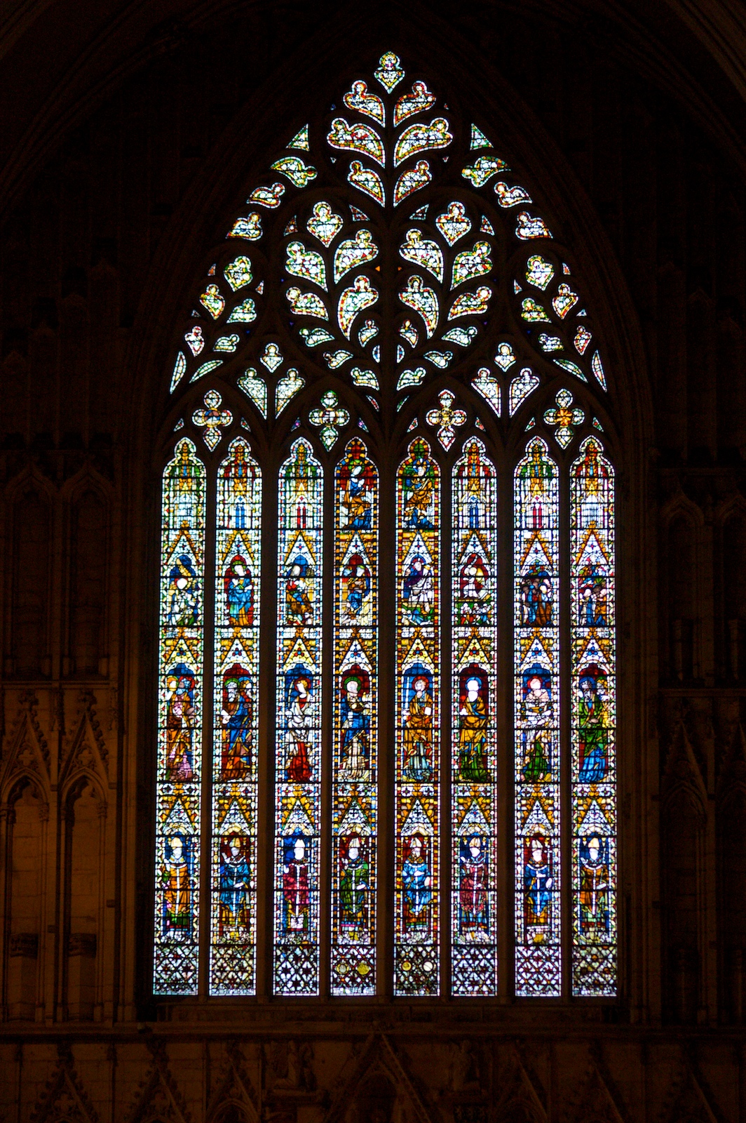 a large, fancy stained glass window showing the cross