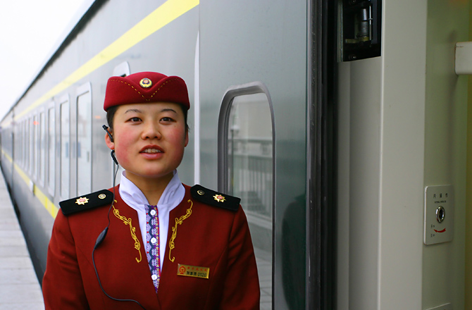 a woman standing in front of a train