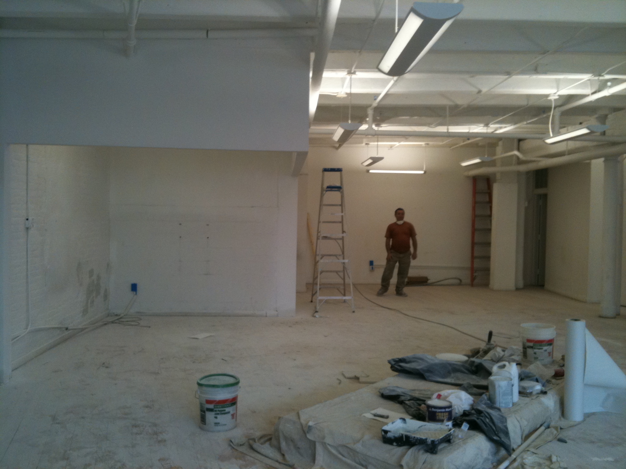 a man is standing next to a ladder inside