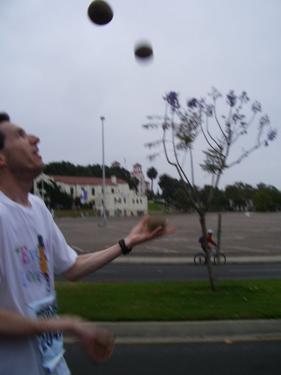 a man juggles a ball across a street