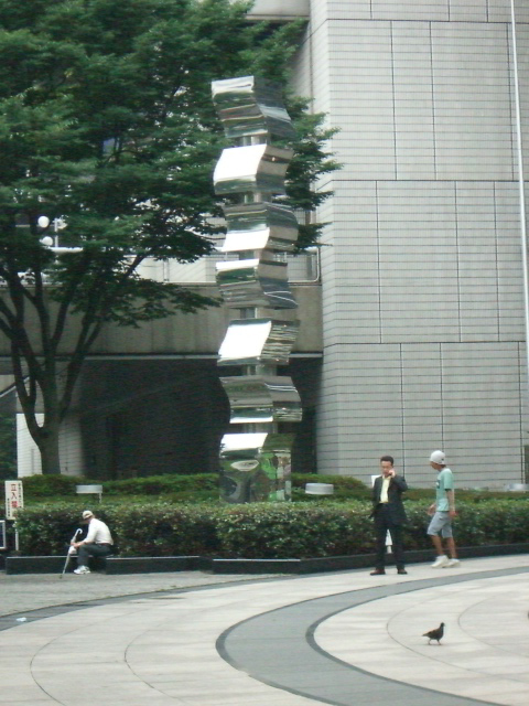 some people walking around a large building in a circle