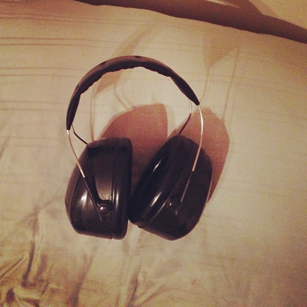 there are two headphones on a bed