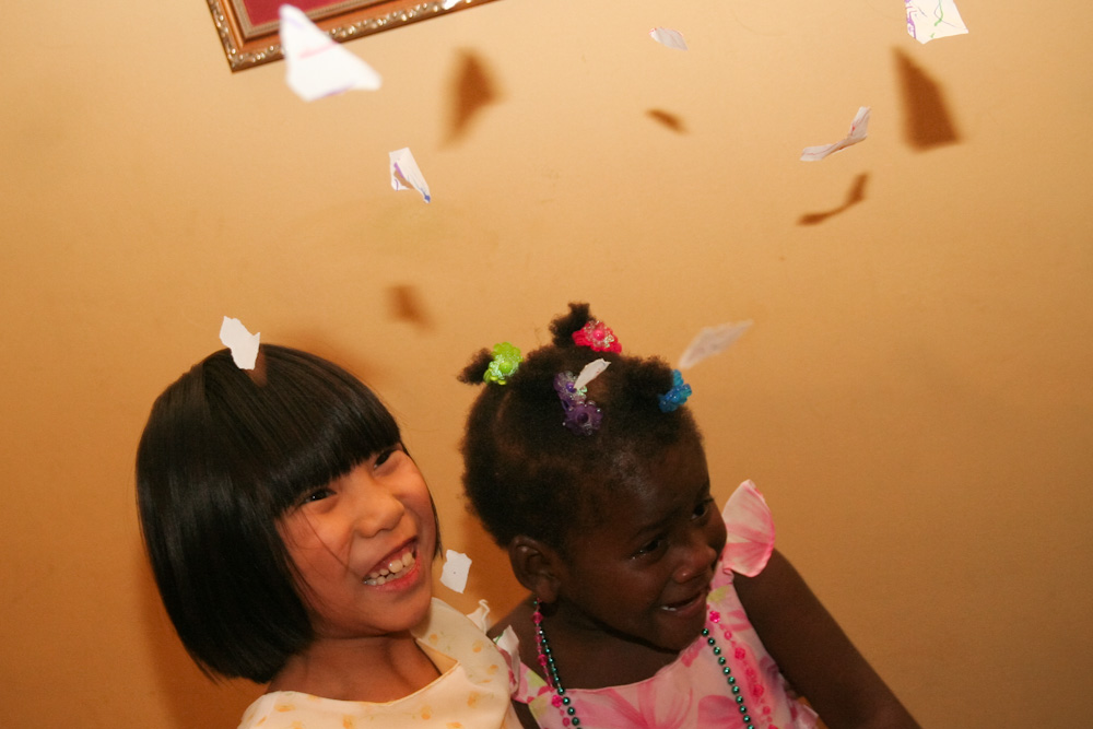 two little girls standing next to each other smiling