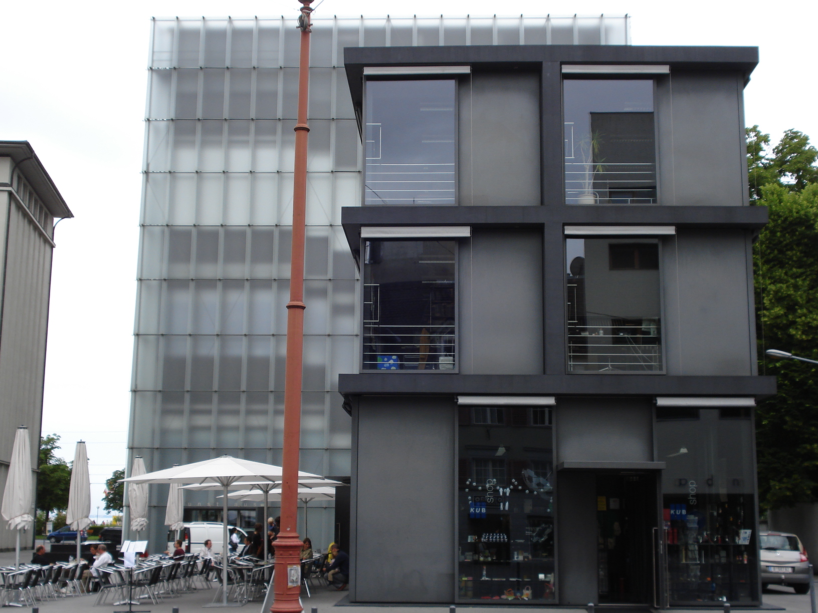 a tall grey building with lots of windows