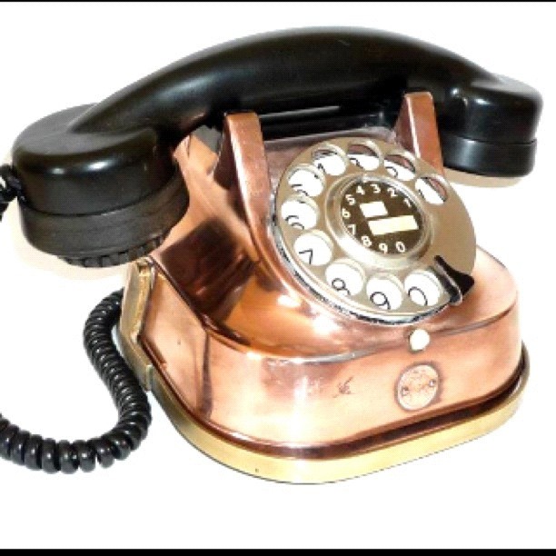 an antique phone with the receiver turned off