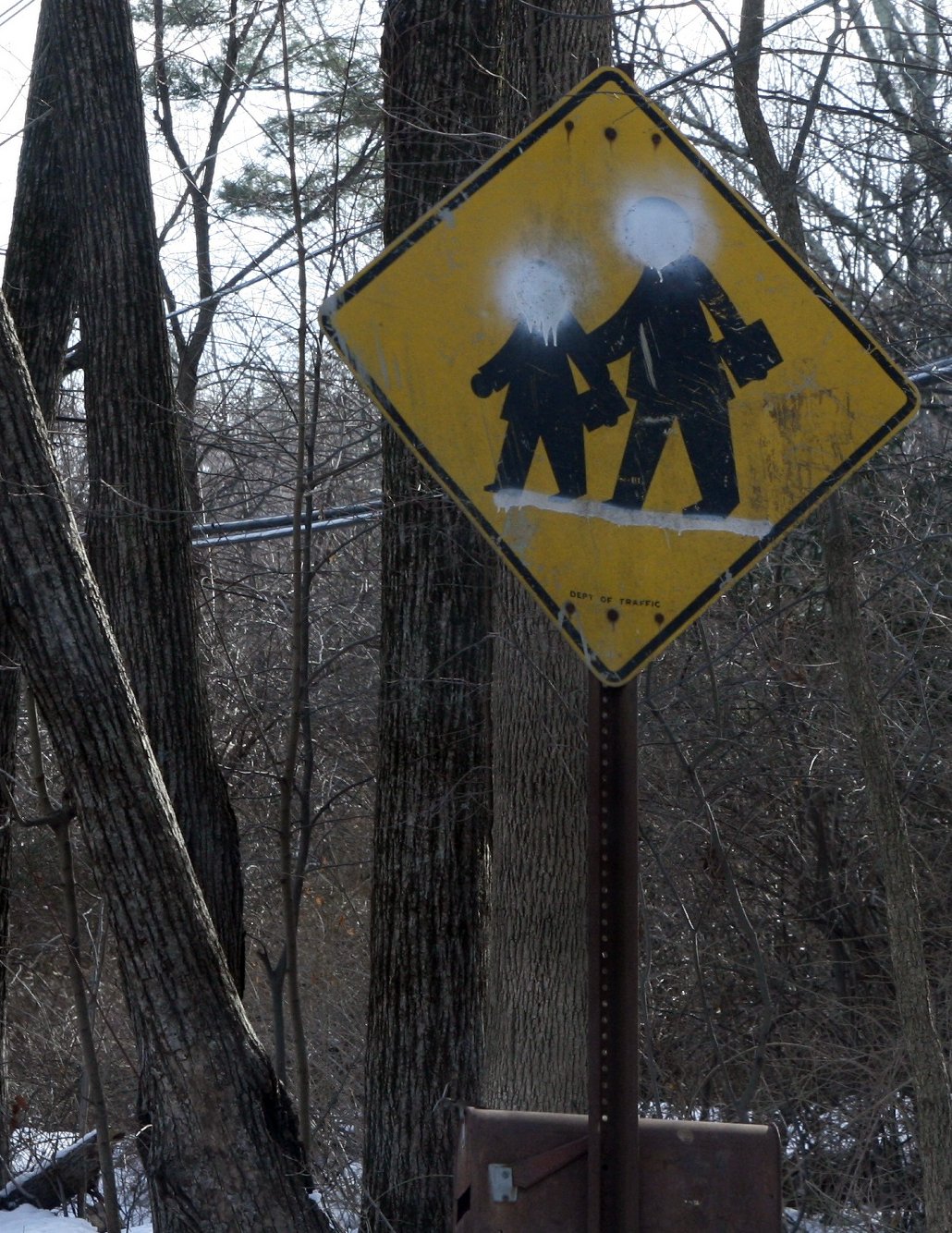 a yellow sign with graffiti depicting two people