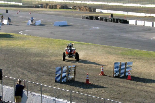 a man in a tractor driving across a track