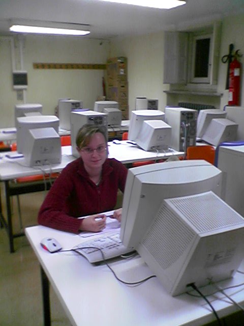 a person sitting at a computer in a room