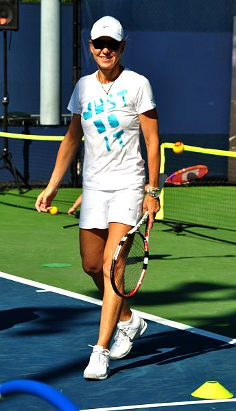 a female tennis player is playing a game of tennis