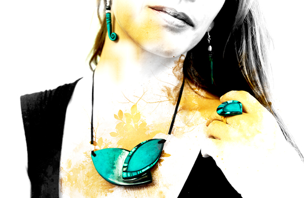 a woman with her shirt pulled back and green earrings