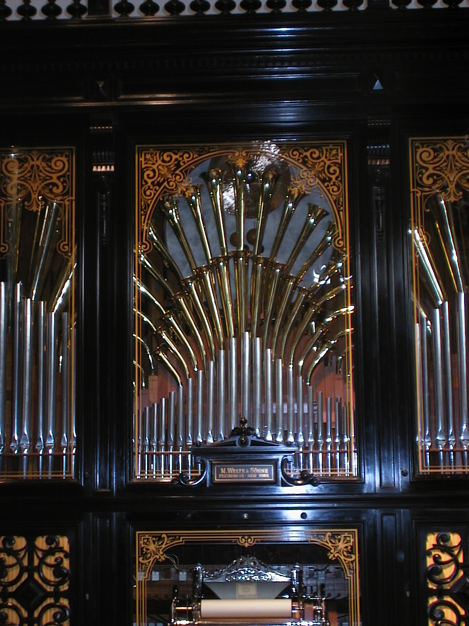 organ and lights, on display in front of windows