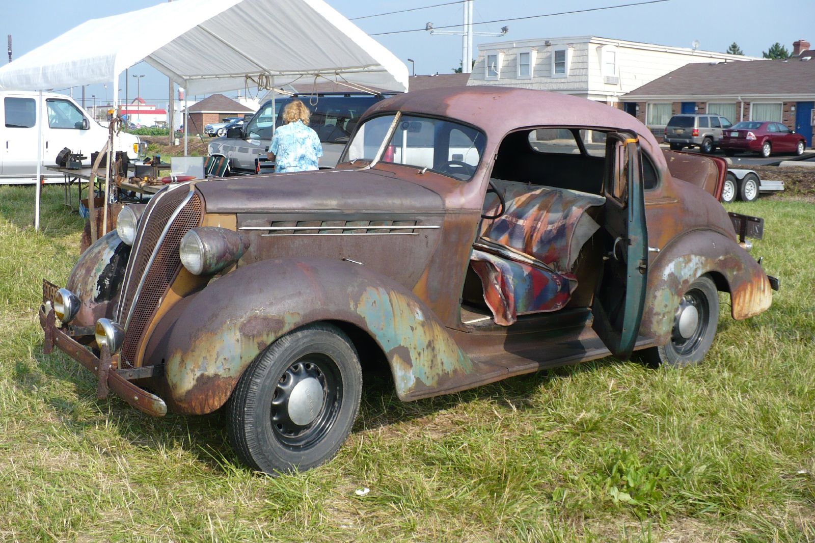 an old car is parked in a field