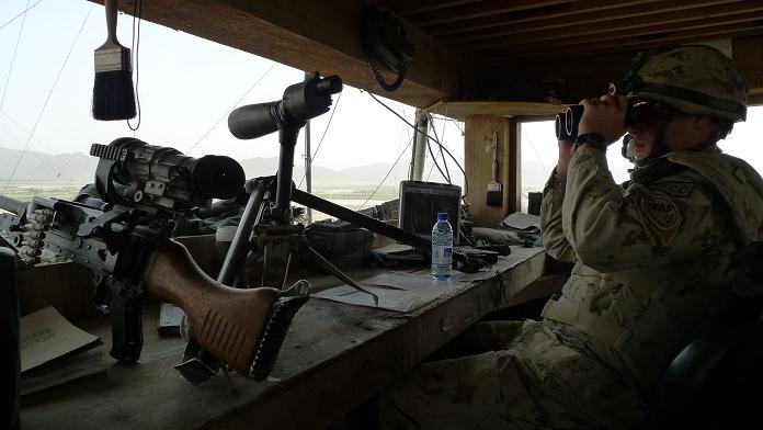 military soldiers inside an army vehicle with large equipment and weapon