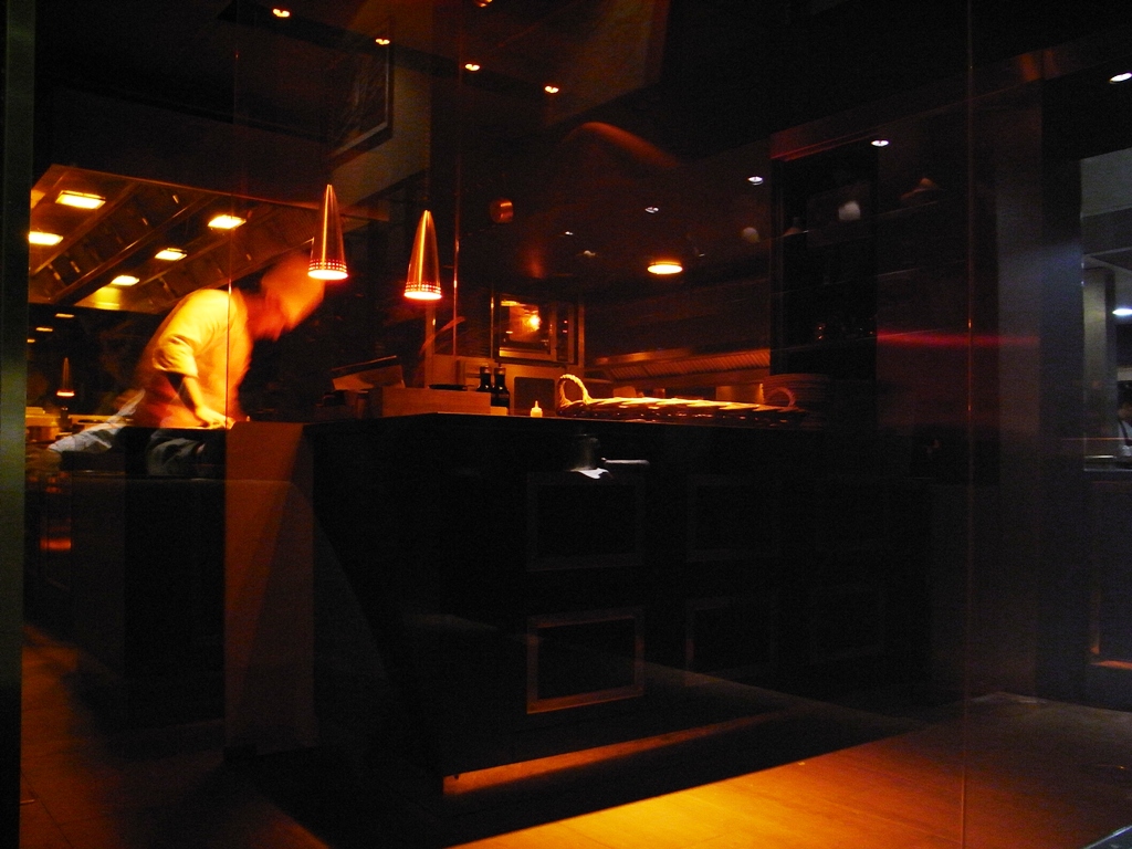 a woman cooking a dinner in the dark