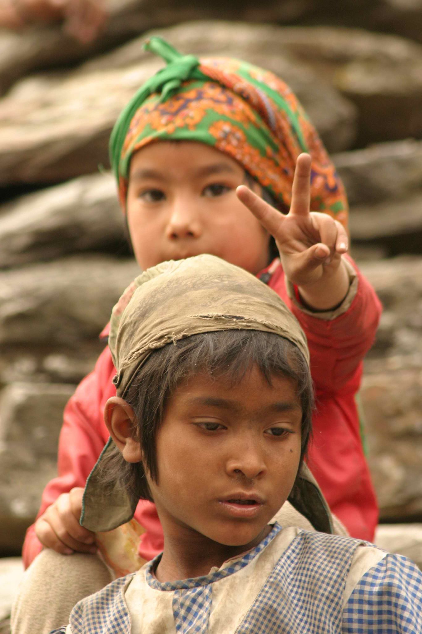 two s posing in the mountains with rock formation in background