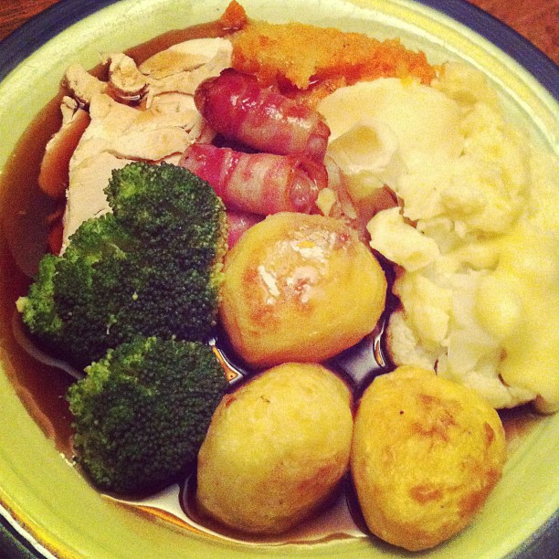 a plate full of roast, potatoes and broccoli