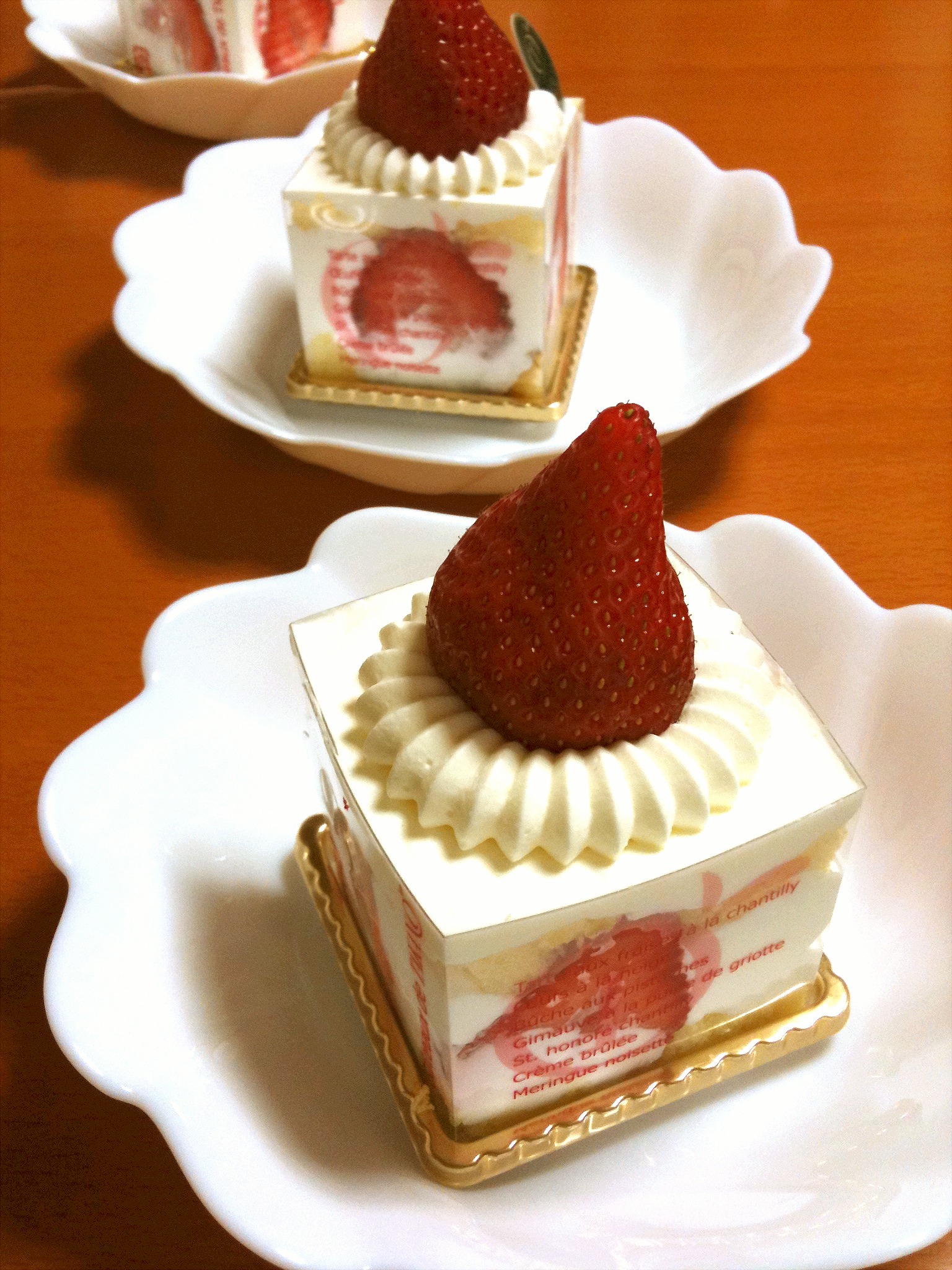 three small desserts with a strawberry on top of it