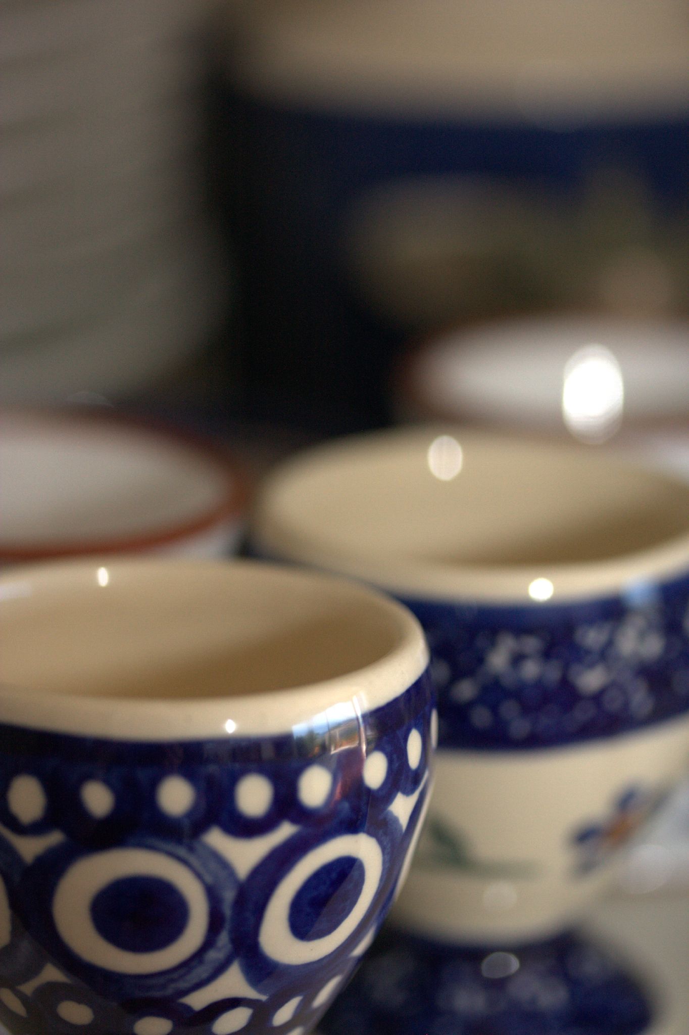 several bowls sit atop a table with blue and white designs