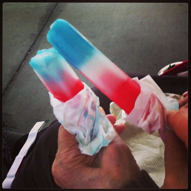 two colored sticks with tissue wrappers on top of them