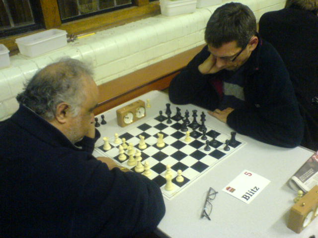a couple of men are playing chess