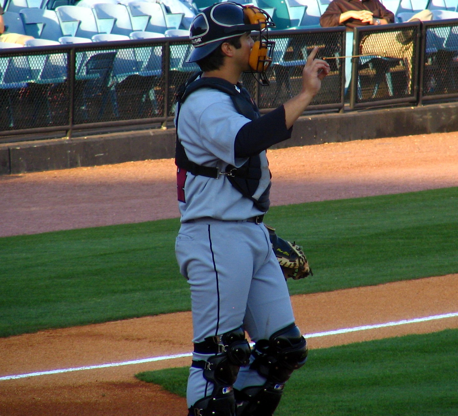 a baseball player standing on a field holding a bat