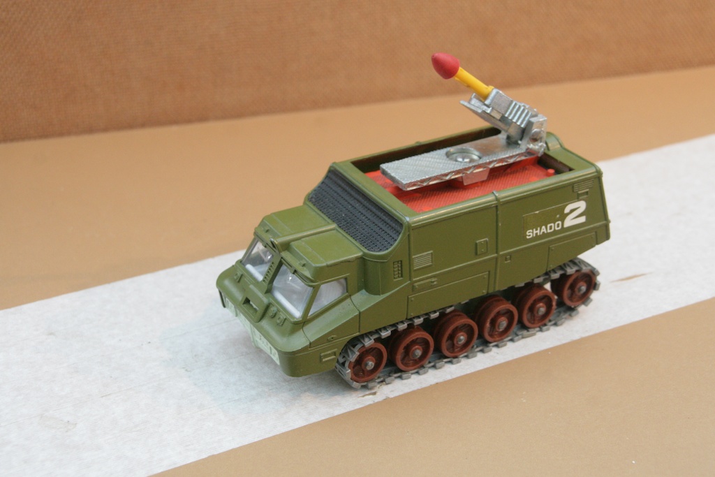 a small army vehicle with bullet and paintbrush attached