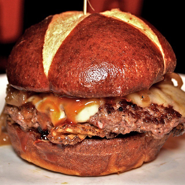 the big cheeseburger is in a thick bun with a beef, caramel and sauce