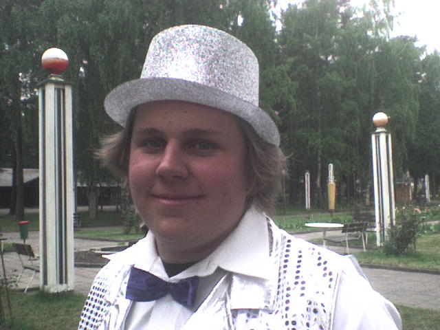 a man wearing a silver top hat and white shirt