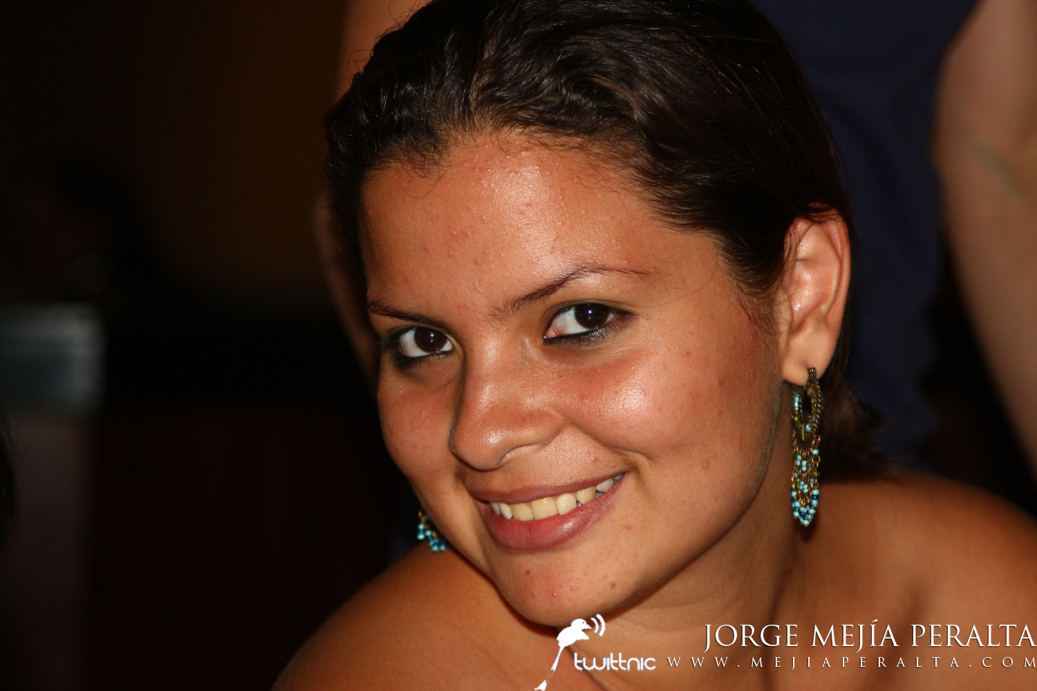 a close up view of a woman wearing earrings