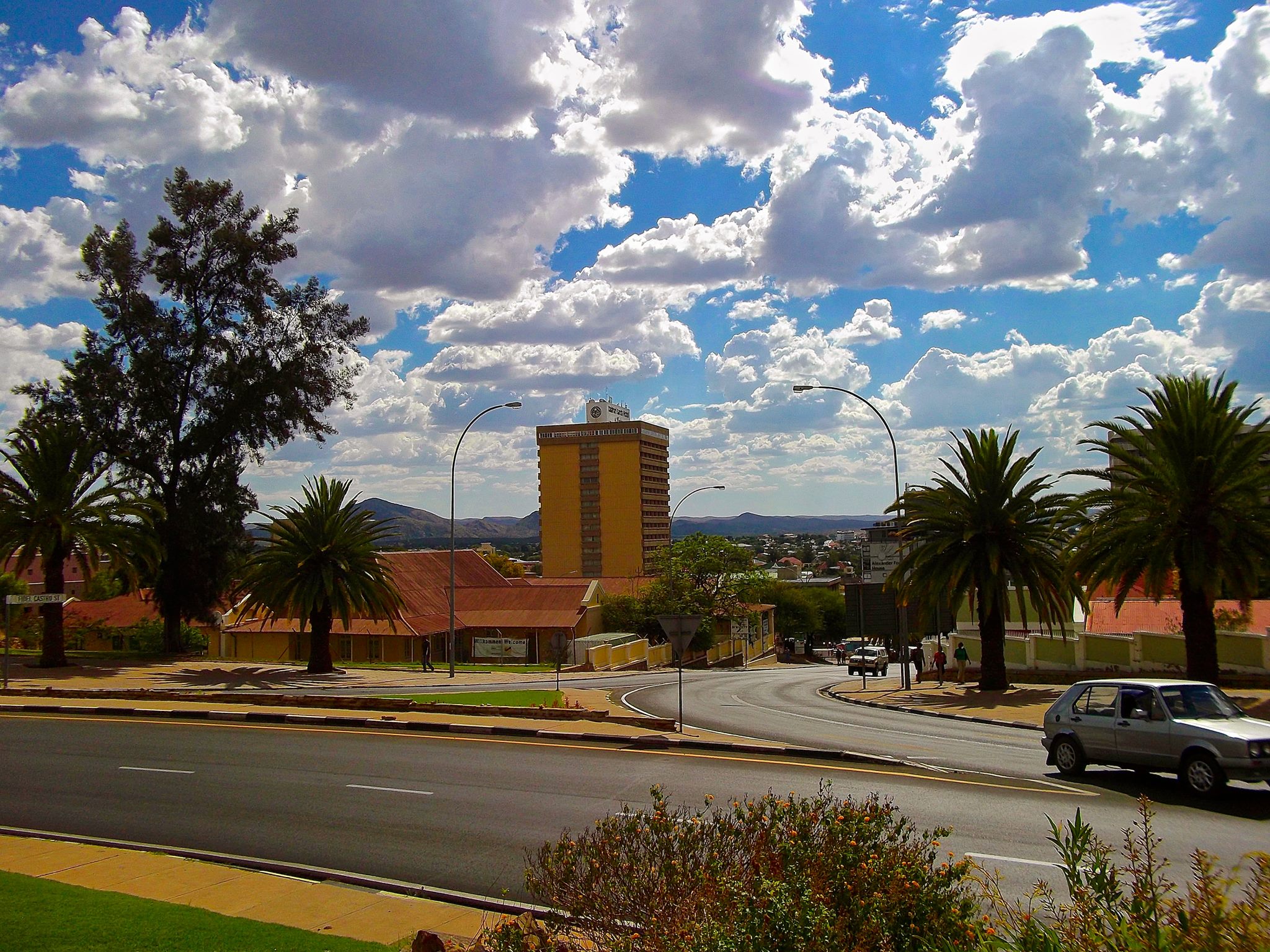 a road with some cars and buildings in the background