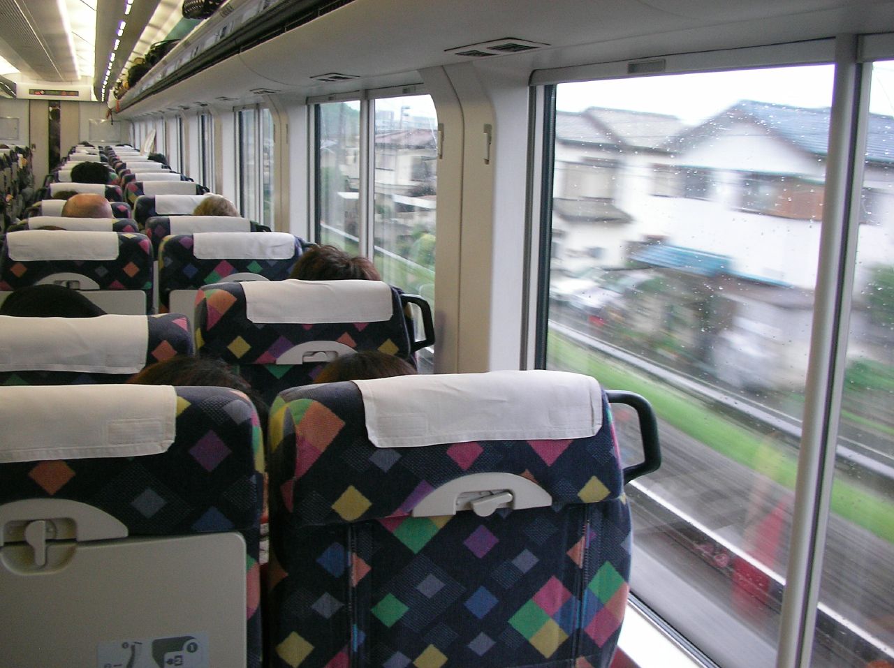 rows of seats in the passenger compartment of an empty train