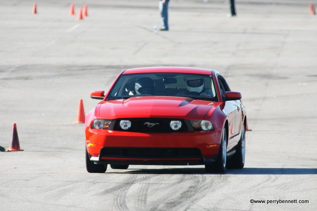 a car driving on a race track with cones around