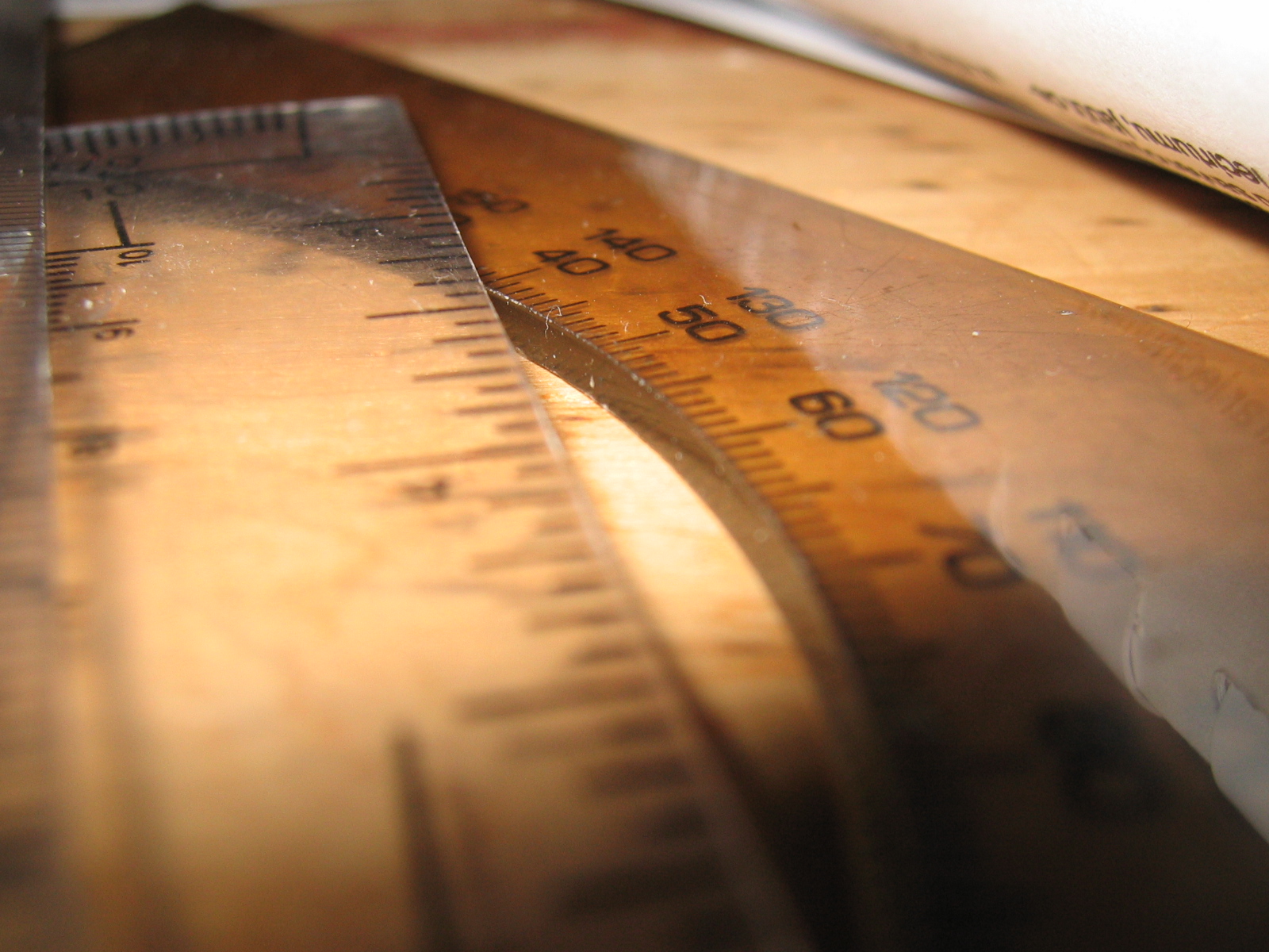 a ruler and a knife laying side by side on a table