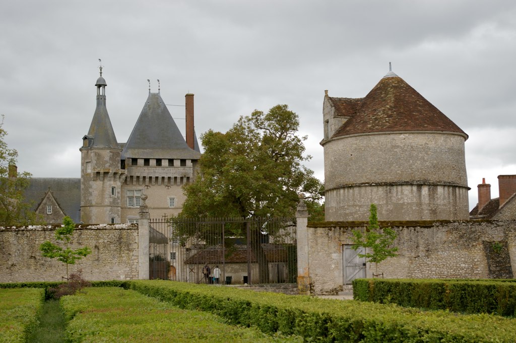 a castle near an ornamental hedge in a country setting