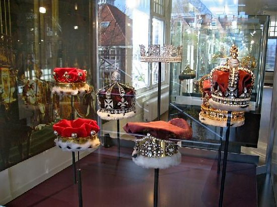 several crown crowns on display in a glass case