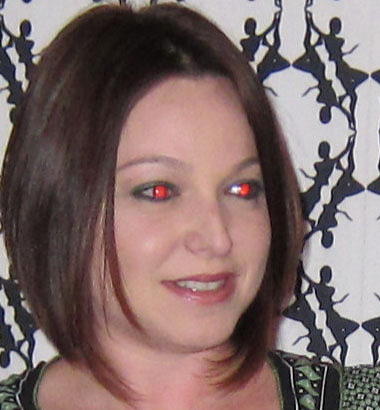 a woman is making funny faces with red eyes