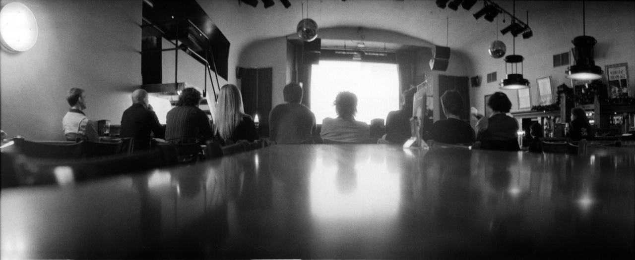 black and white pograph of people at a counter