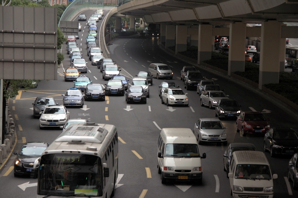 a group of cars travelling down a city street