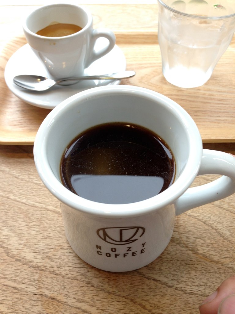 the large cup of coffee is placed next to a smaller cup