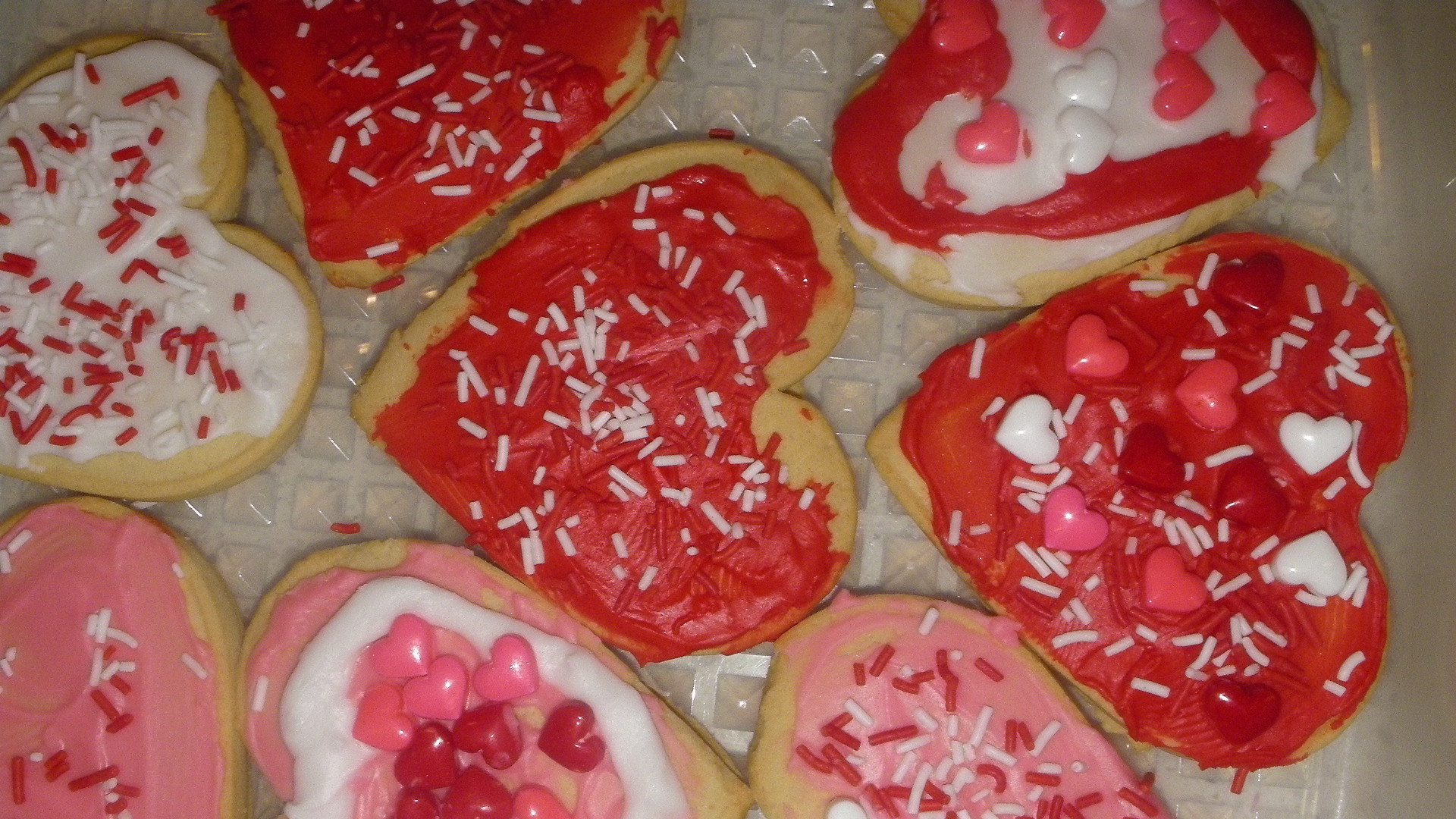 a number of decorated cookies in a box