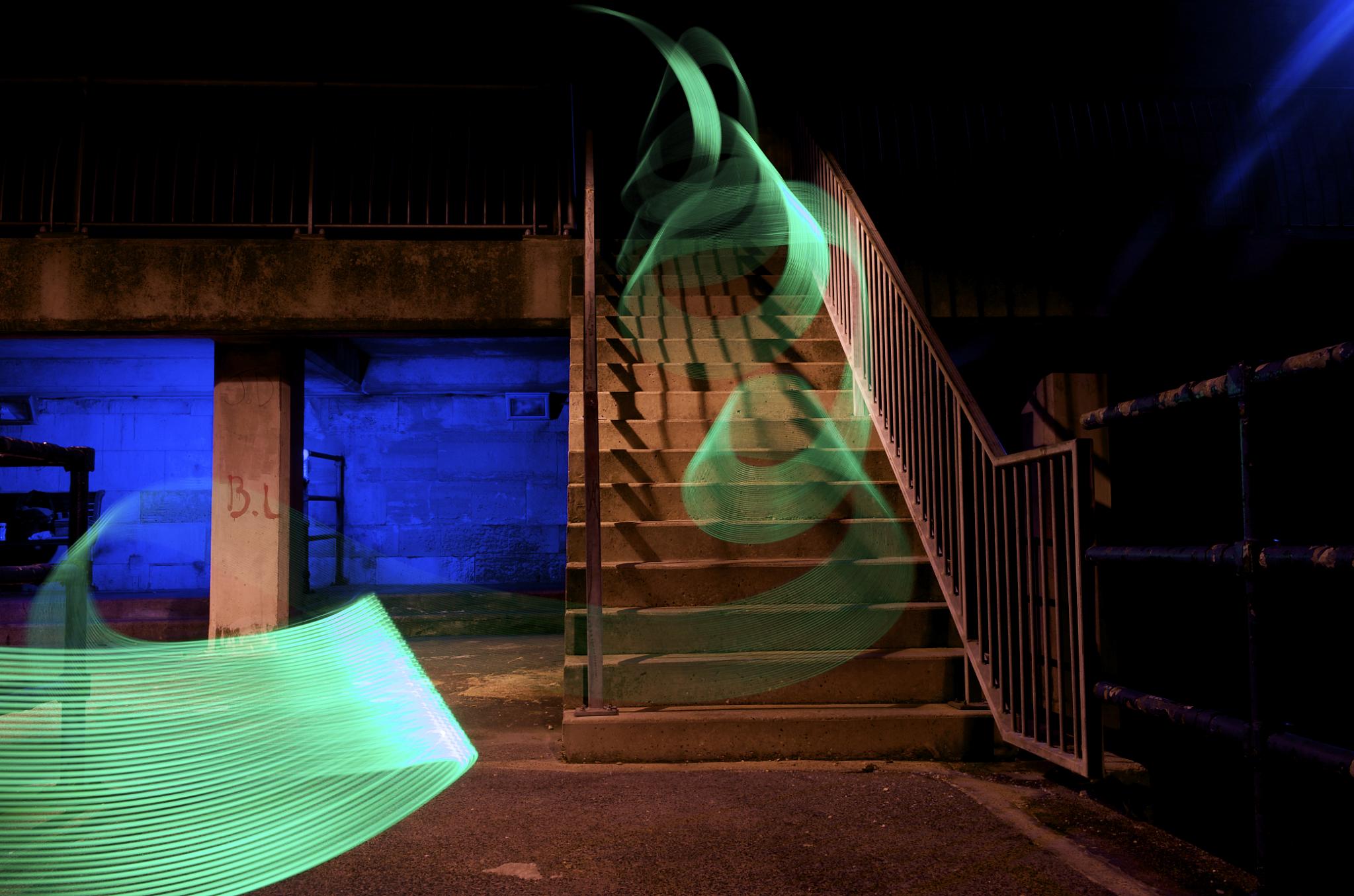 motion capture image at nighttime of light streaming down stairways